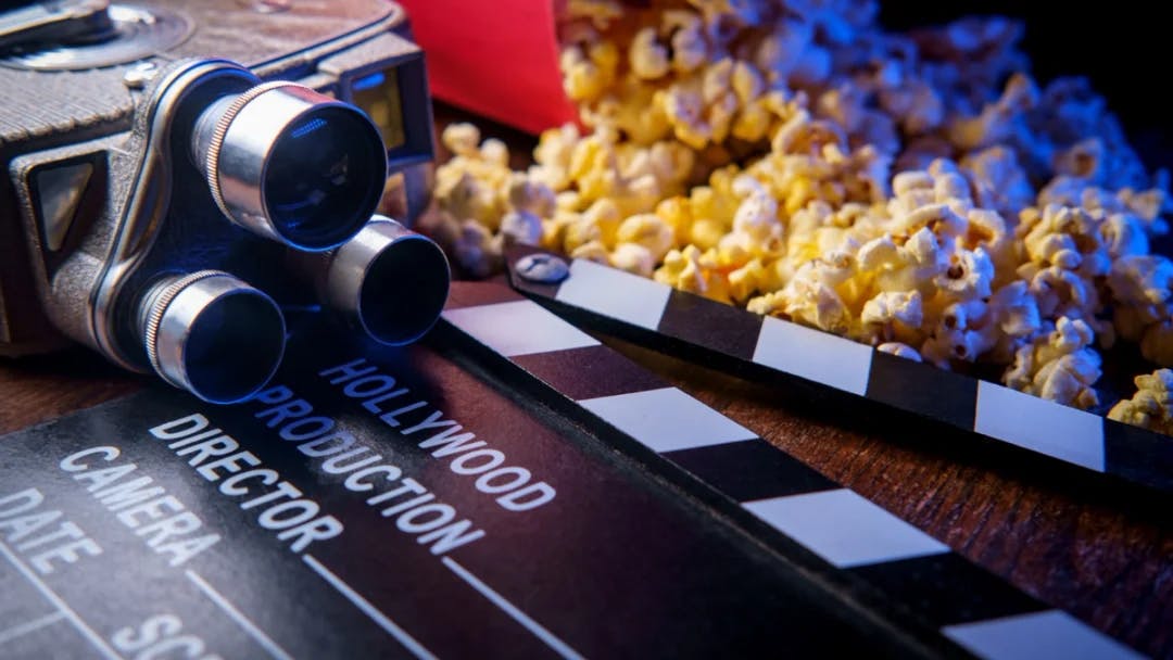 Et illustrasjonsbilde av et filmkamera og popcorn